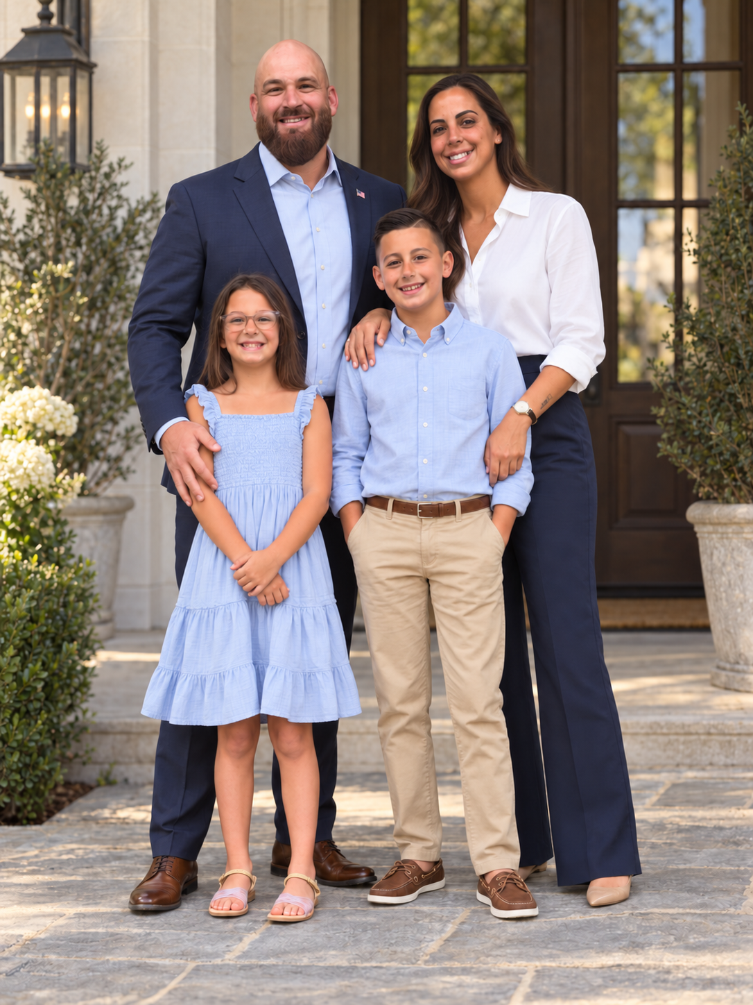 Illustrative portrait based on a supplied family photo: Rob Hamilton with his wife Kristen and their two children, all fully in frame